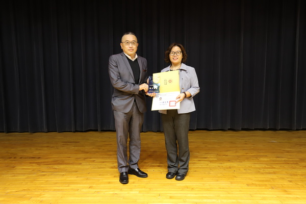 1-1.黄荣鹏校长(图左)颁发教师升等奖给予休运系陈淑贞(图右)升等教授证书及纪念牌